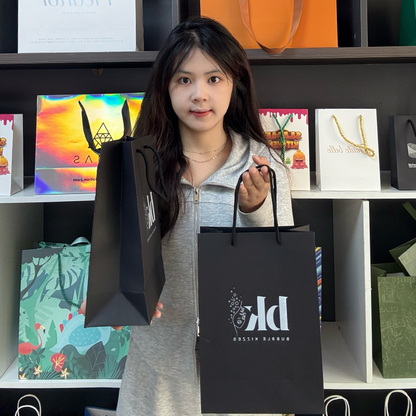 Black pattern printed white paper bag